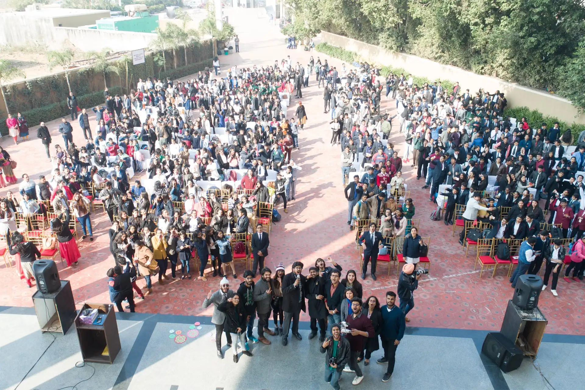 assembly of people looking towards drone camera